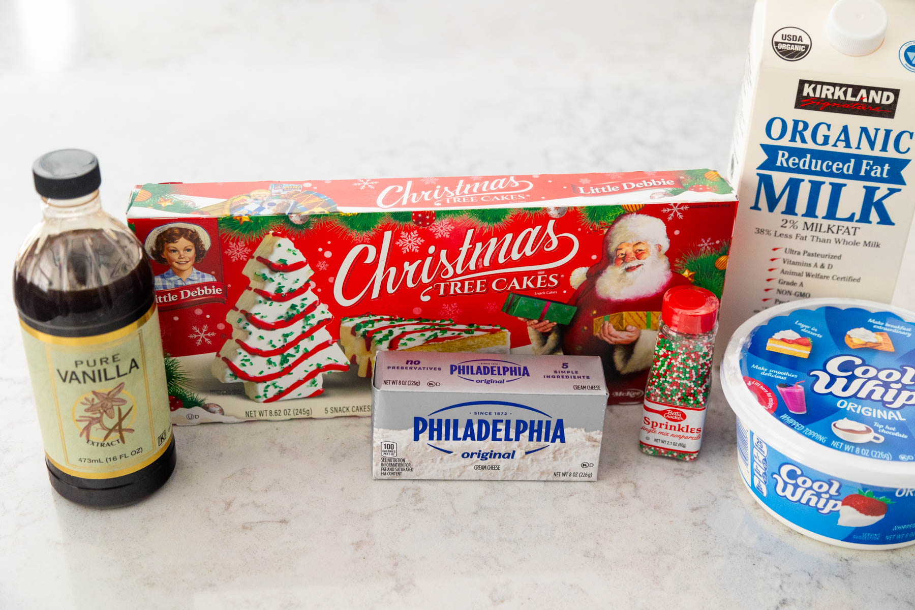 A box of Little Debbie Christmas Tree cakes is on the counter next to the ingredients to turn it into a dip.