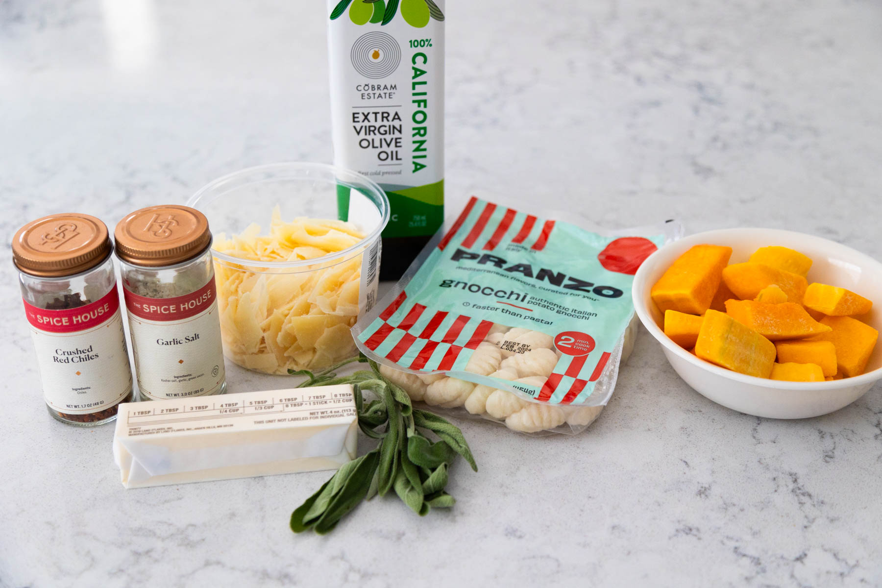 All the ingredients to make roasted gnocchi with butternut squash are on the counter.