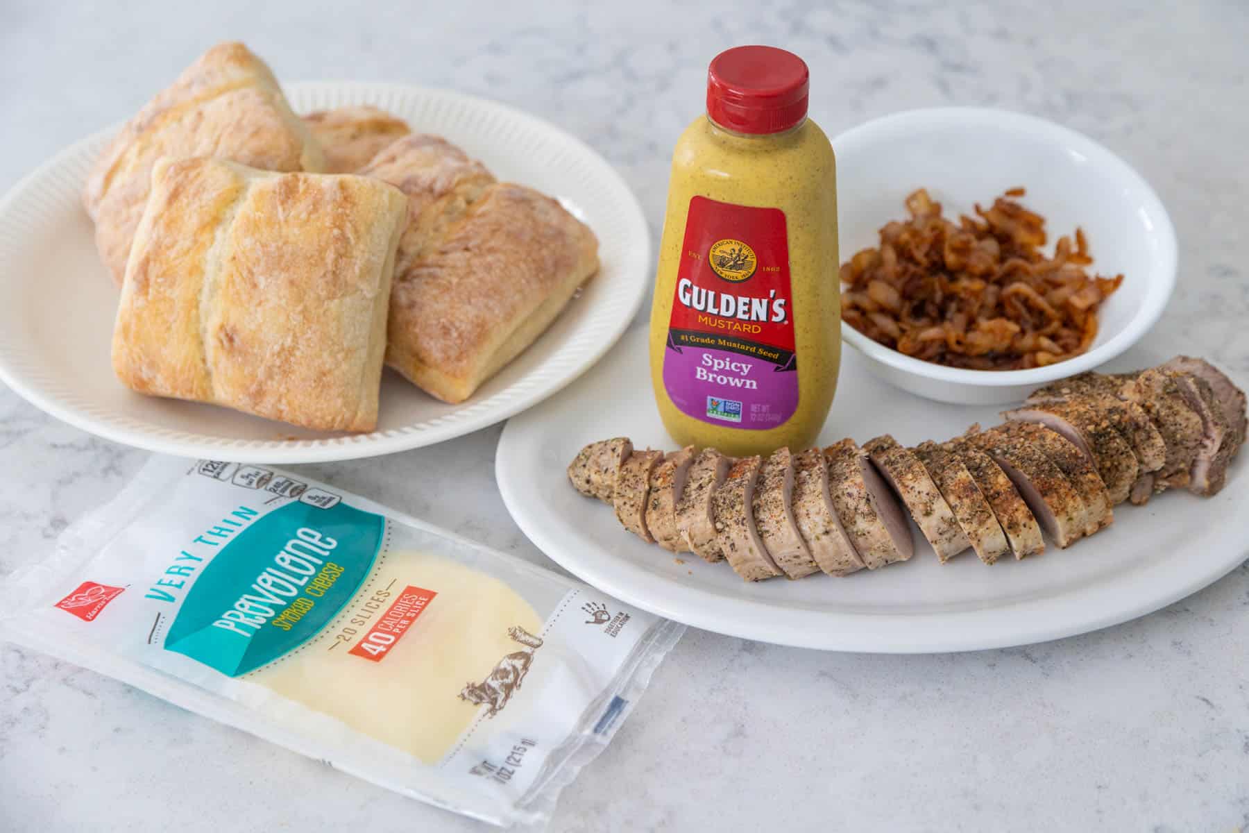 The ingredients to make the roasted pork sandwich are on the kitchen counter.