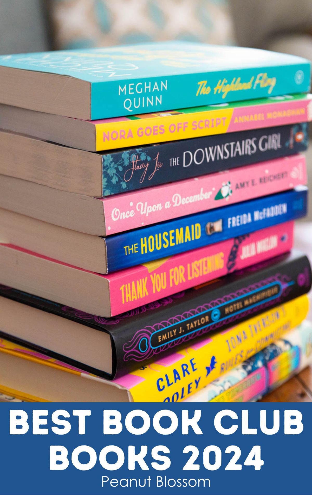 A stack of books from the new book club list sit on the table.