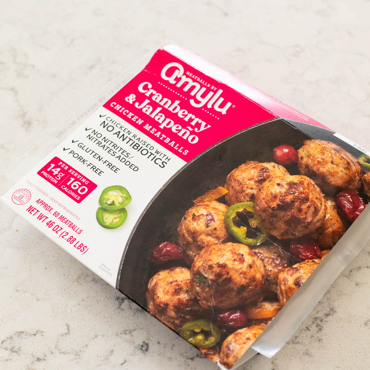A package of Amylu Cranberry Jalapeño Meatballs from Costco sits on the counter.