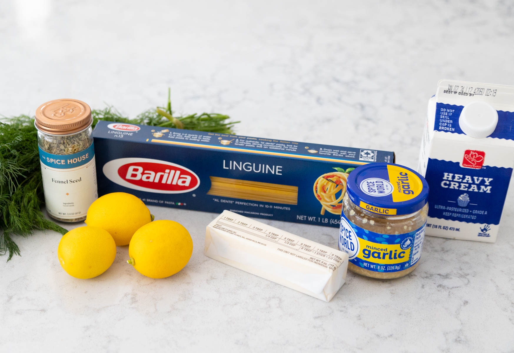 The box of pasta and ingredients to make the lemon cream sauce are on the counter.