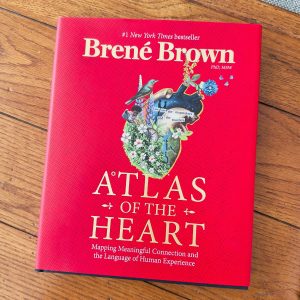 A copy of Atlas of the Heart sits on the table.