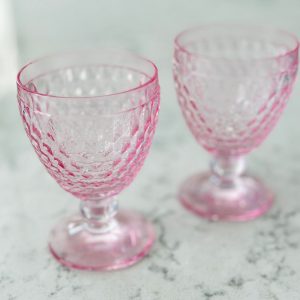 A pair of pink crystal goblets.