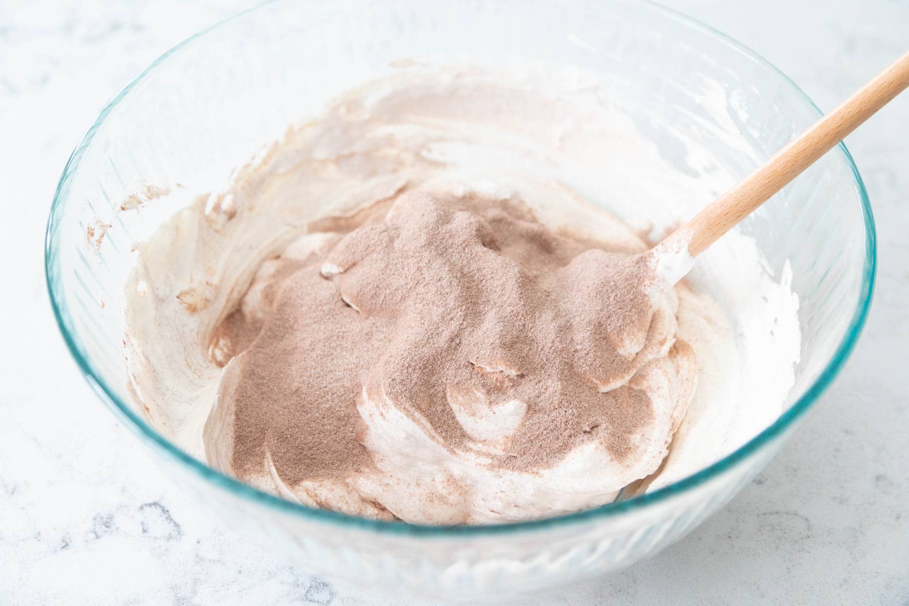 The ingredients are in a large mixing bowl being stirred together.