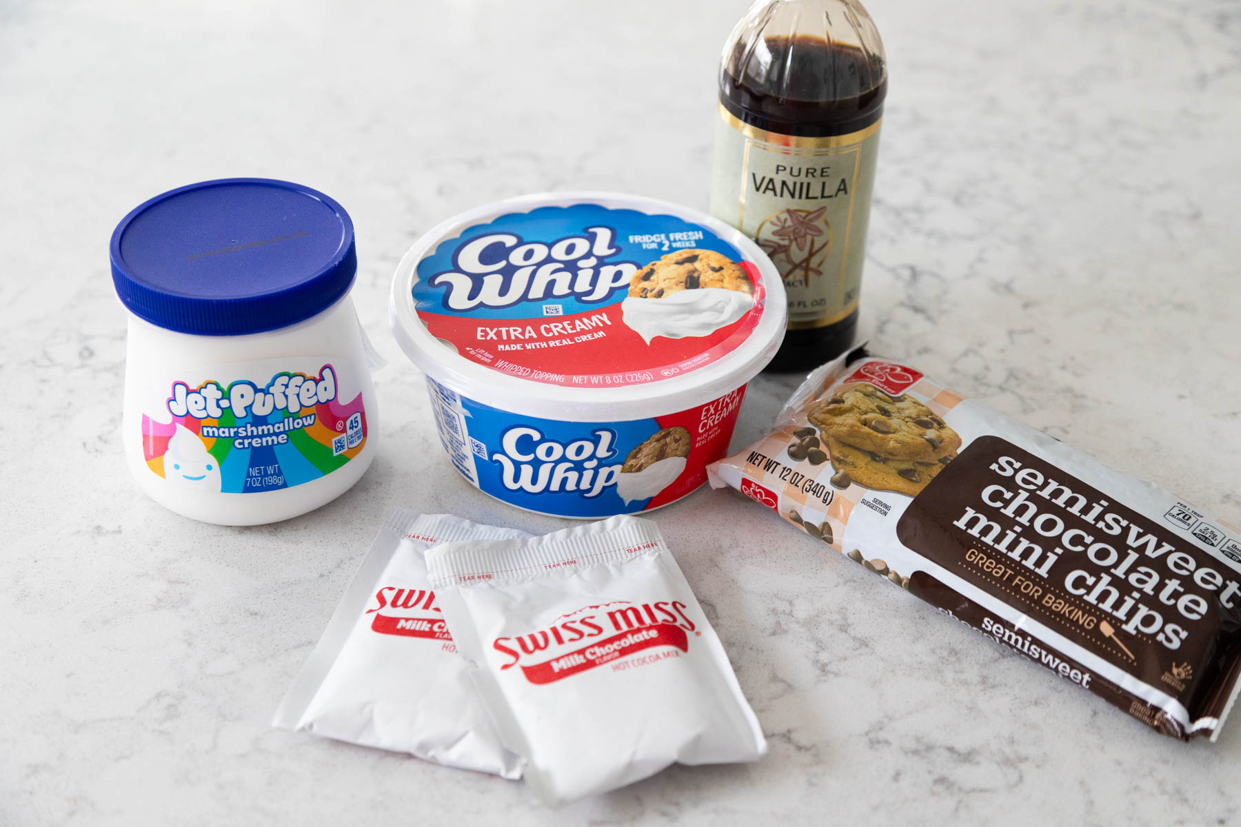 The ingredients to make Hot Cocoa Cheesecake Dip are on the counter.