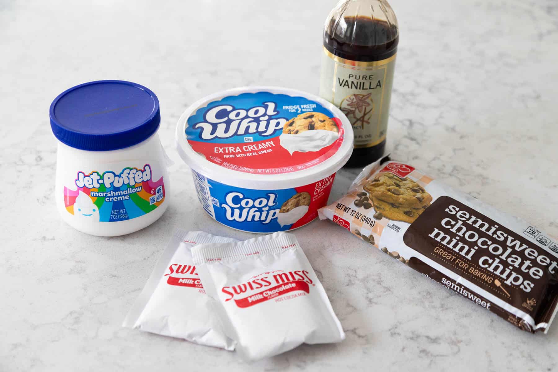 The ingredients to make Hot Cocoa Cheesecake Dip are on the counter.