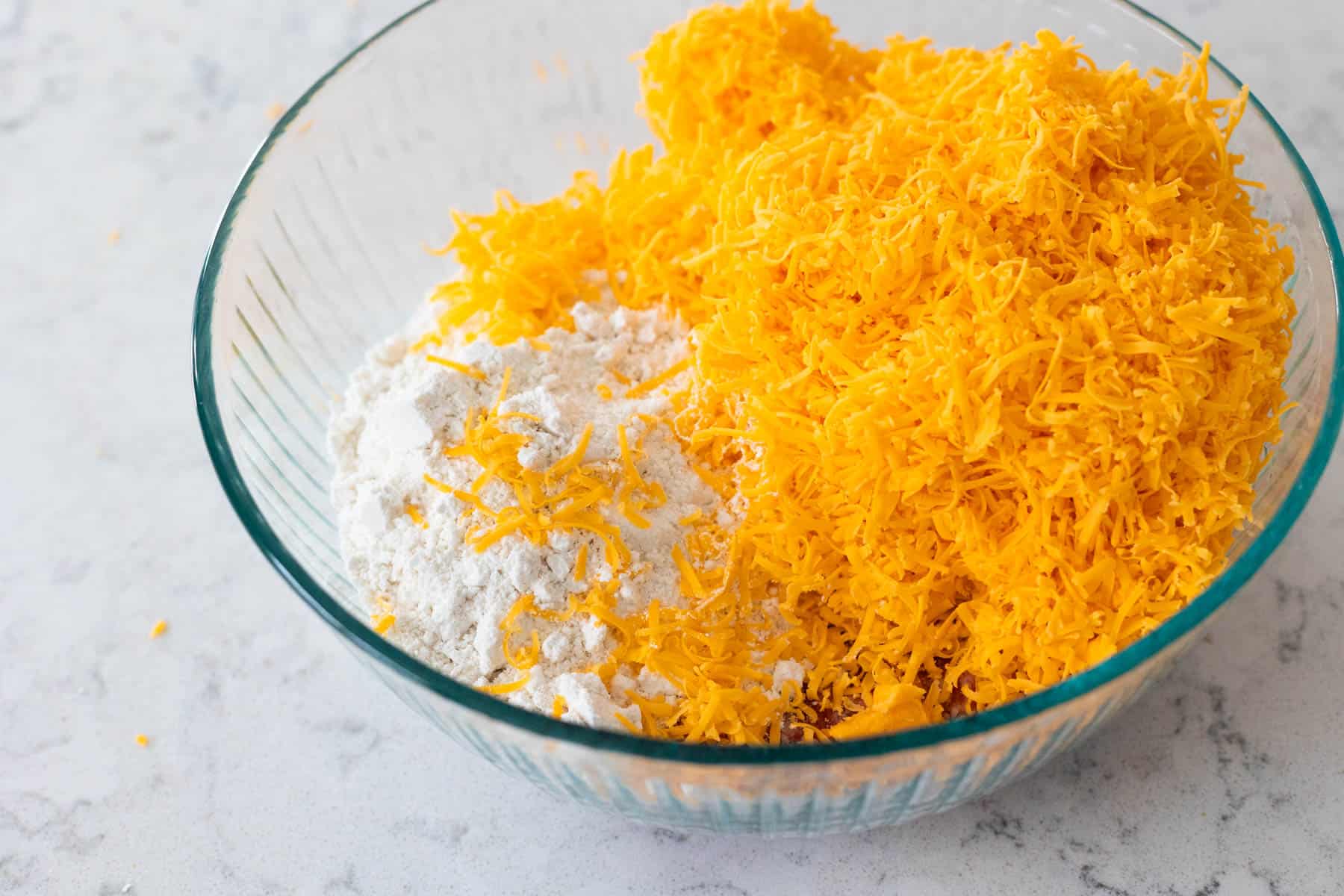 The large mixing bowl shows just how much cheddar cheese is involved in this recipe.