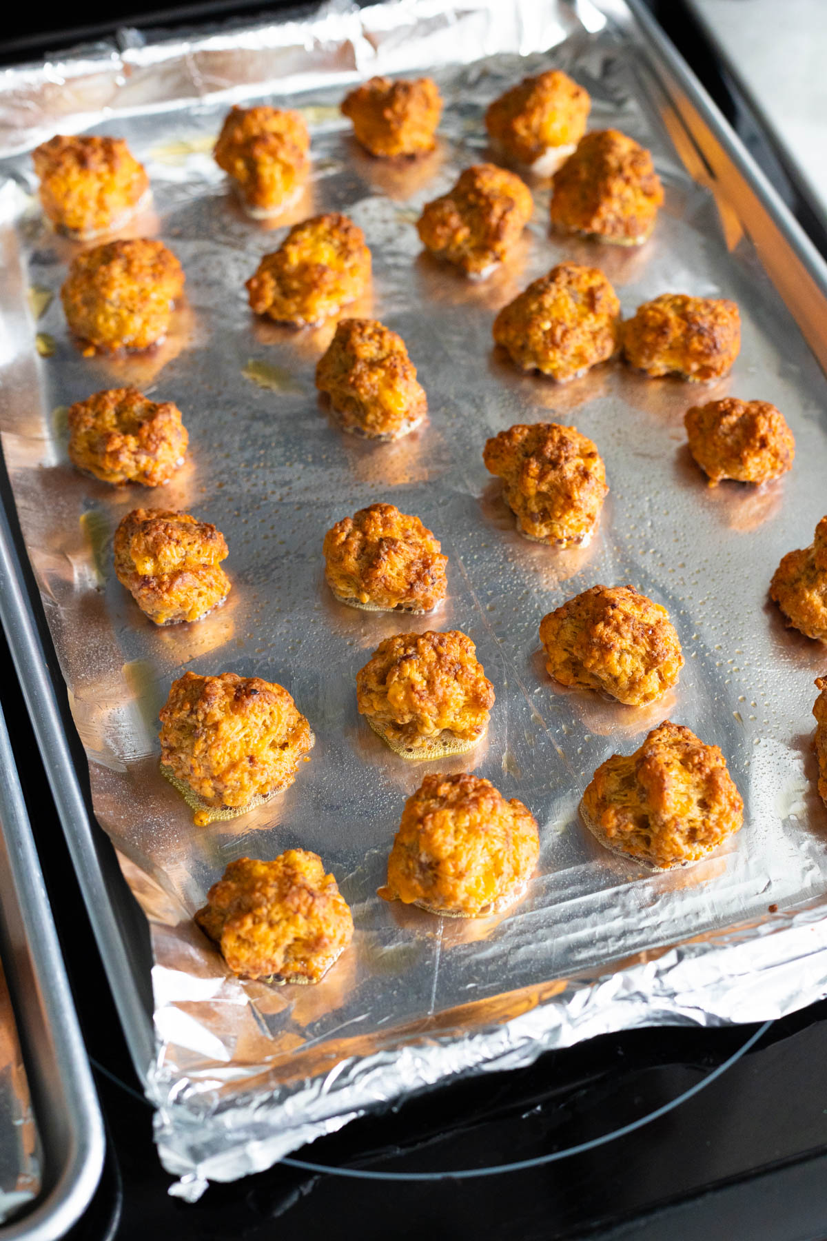 The sausage balls are fresh from the oven and are golden brown.