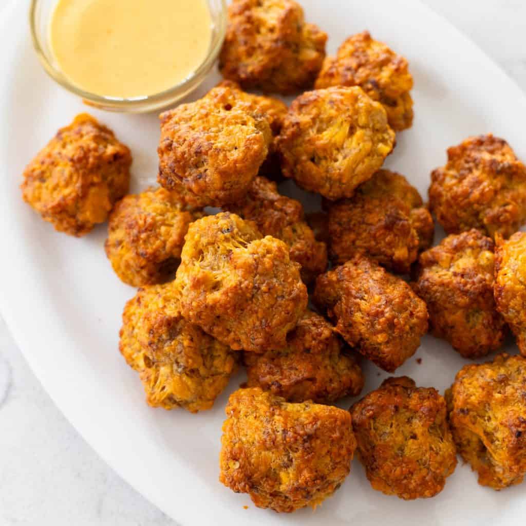 A white platter filled with Bisquick sausage balls made with just three ingredients