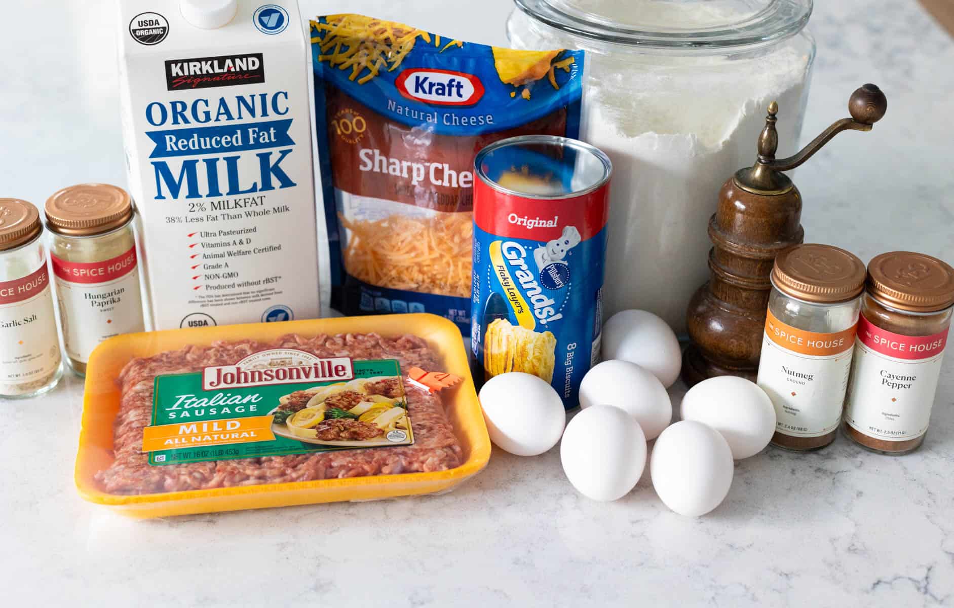 The ingredients to make a biscuits and gravy casserole with sausage are on the counter.