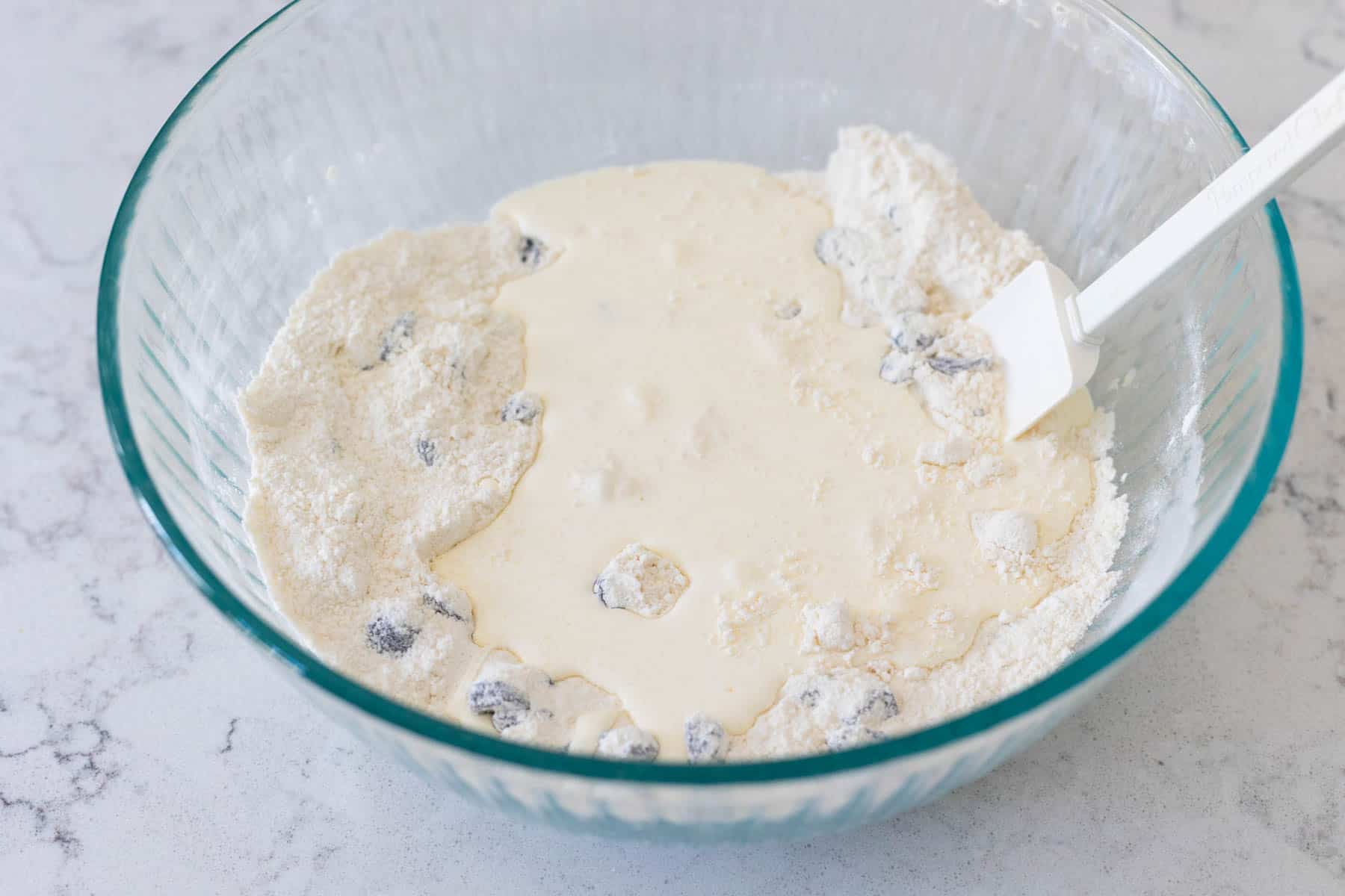 The heavy cream has been added to the mixing bowl.