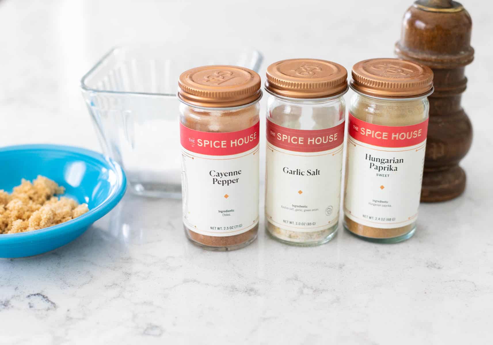 The spice jars are lined up on the kitchen counter.