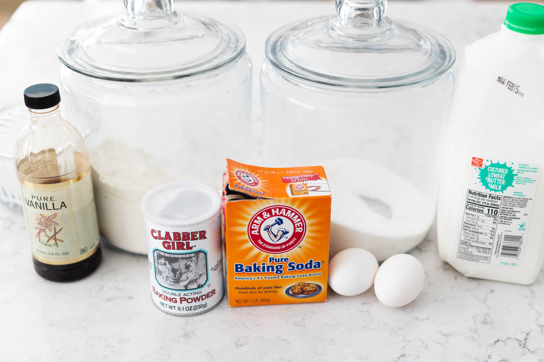 The ingredients to make homemade buttermilk pancakes are on the counter.