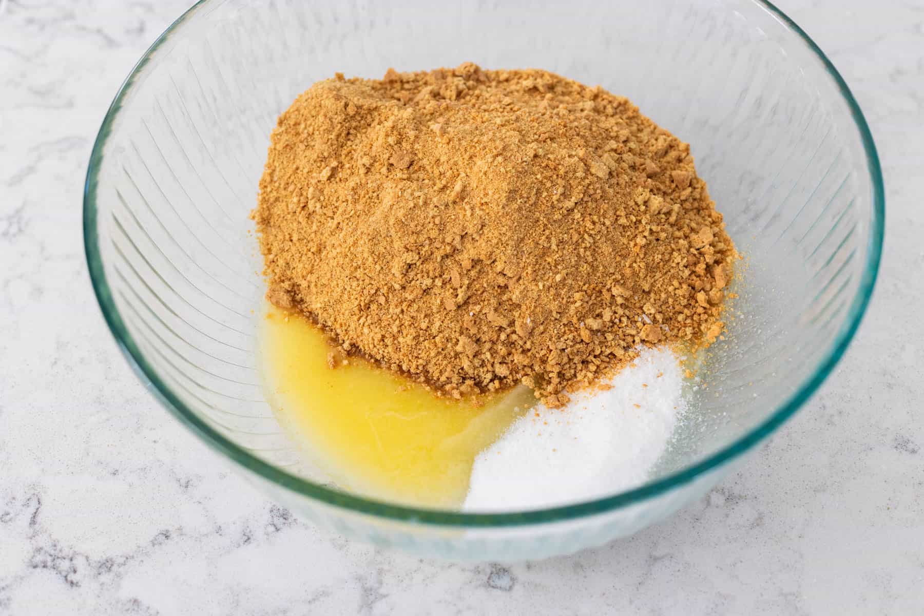 The mixing bowl shows the graham cracker crust about to be mixed together.