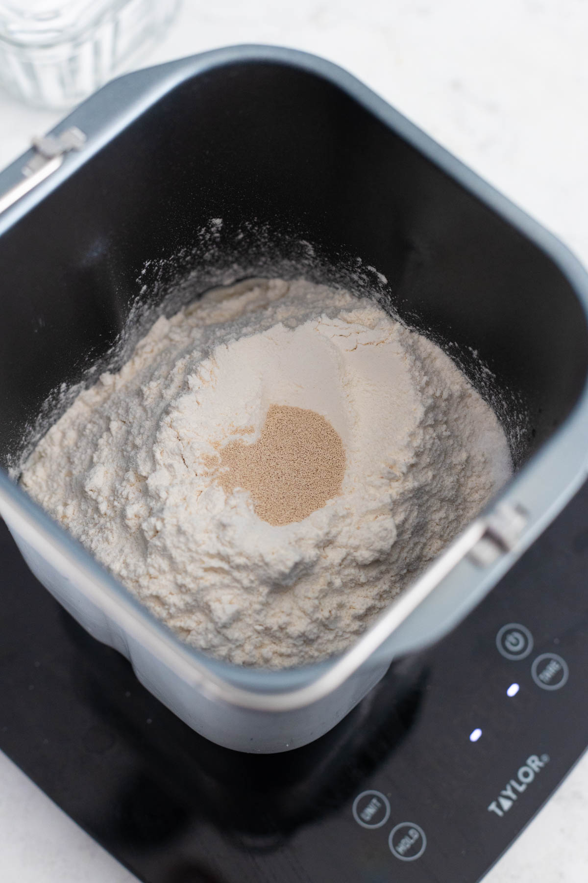 The flour and yeast are in the bread maker pan.