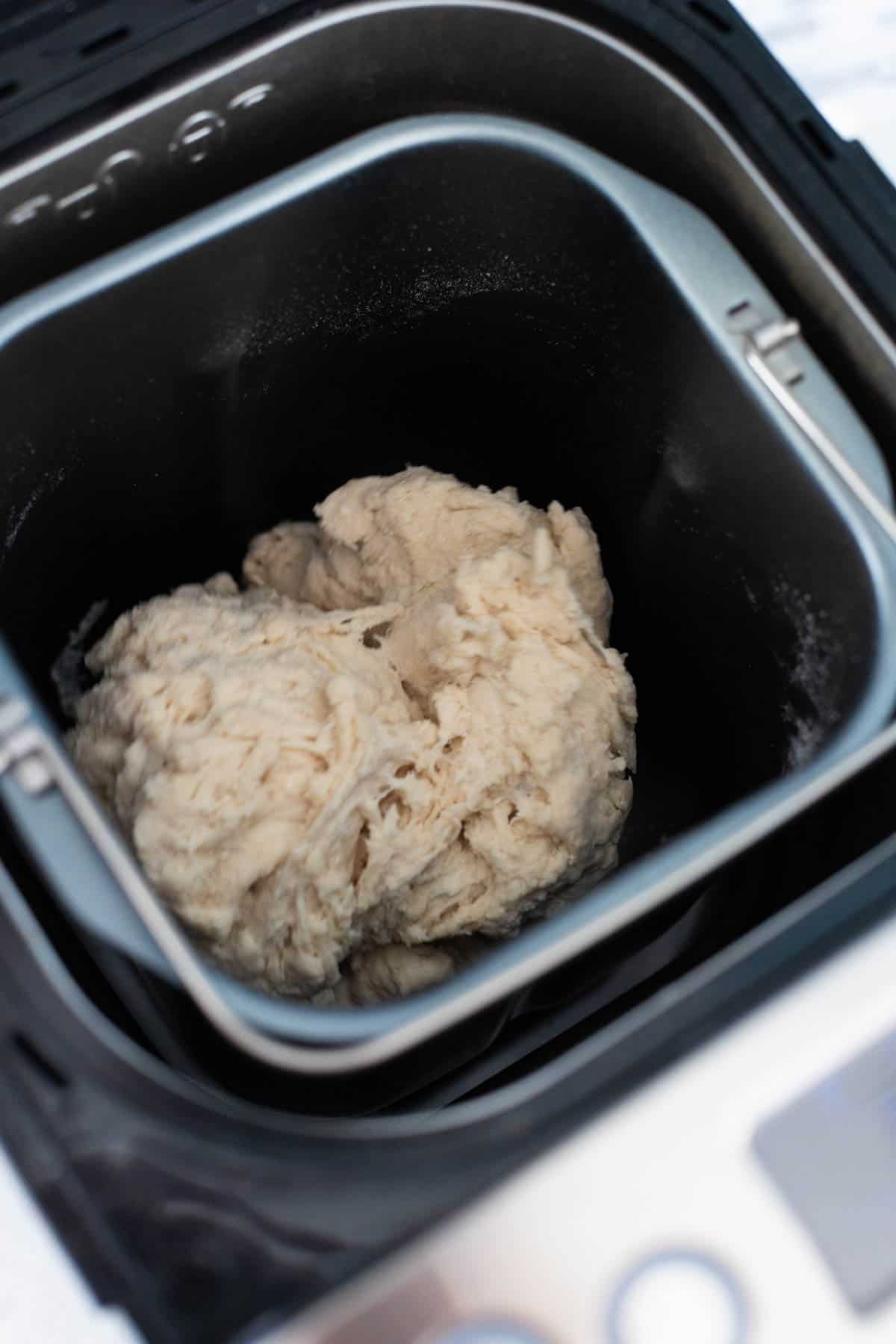 The dough is being kneaded in the bread pan.