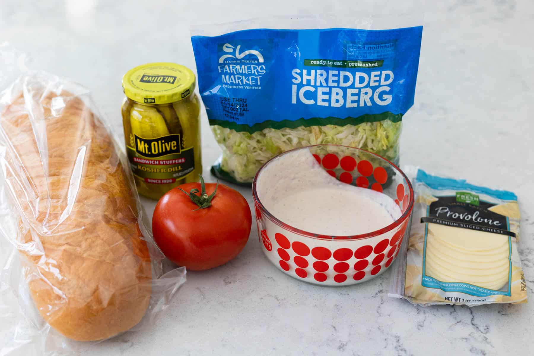 The remaining ingredients to turn the beef into a po'boy sandwich are on the counter.