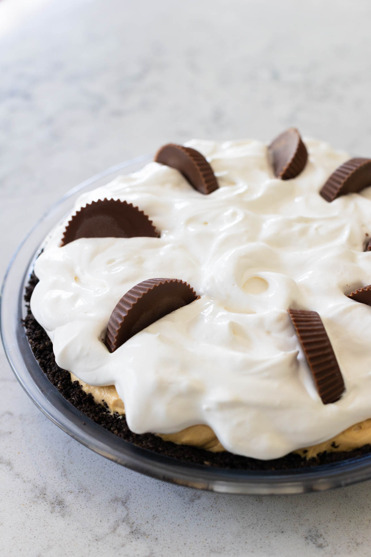 The sliced Reese's peanut butter cups have been added to the top of the pie for decoration.
