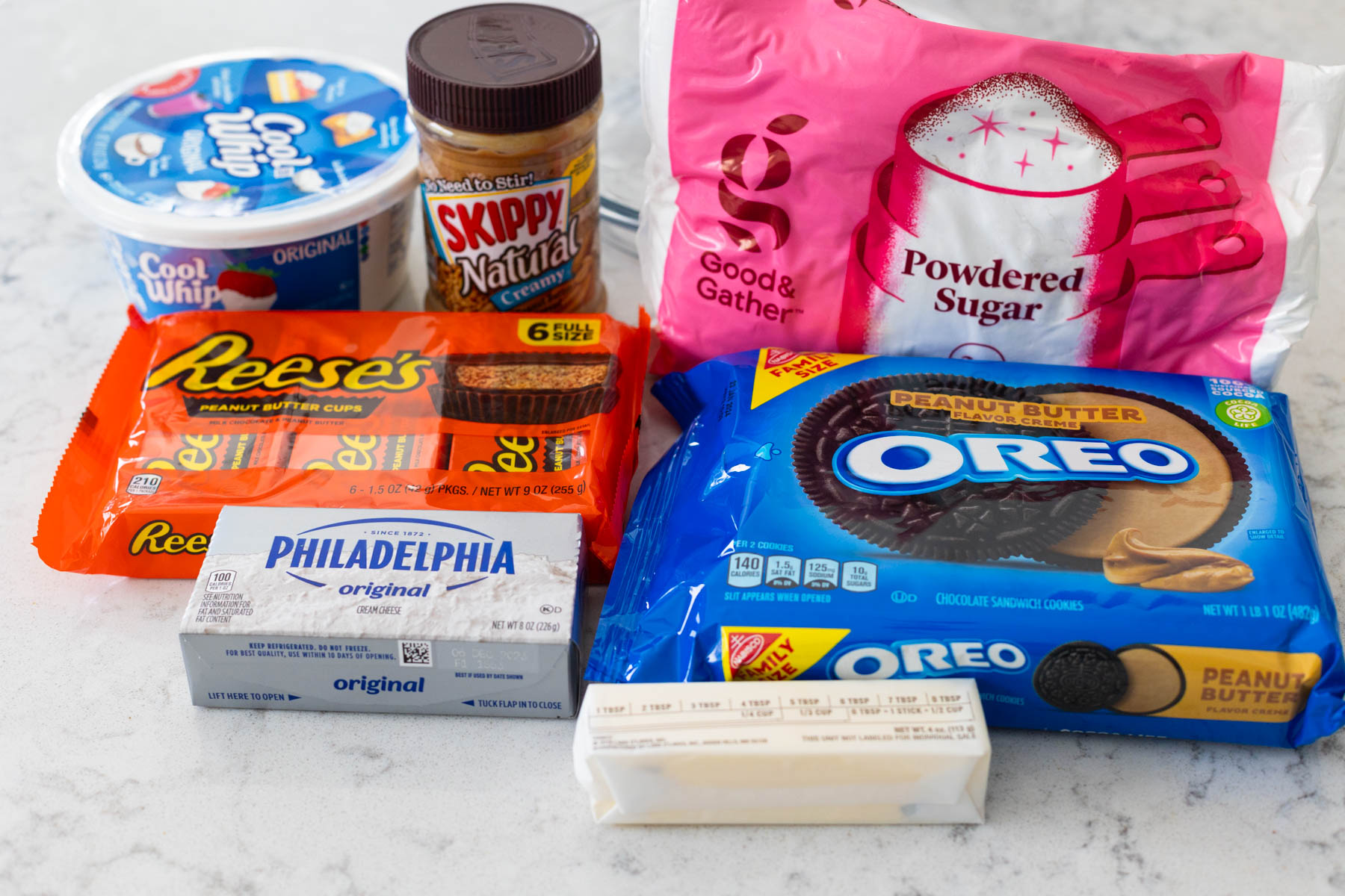 The ingredients to make the Reese's  peanut butter cup pie are on the counter.