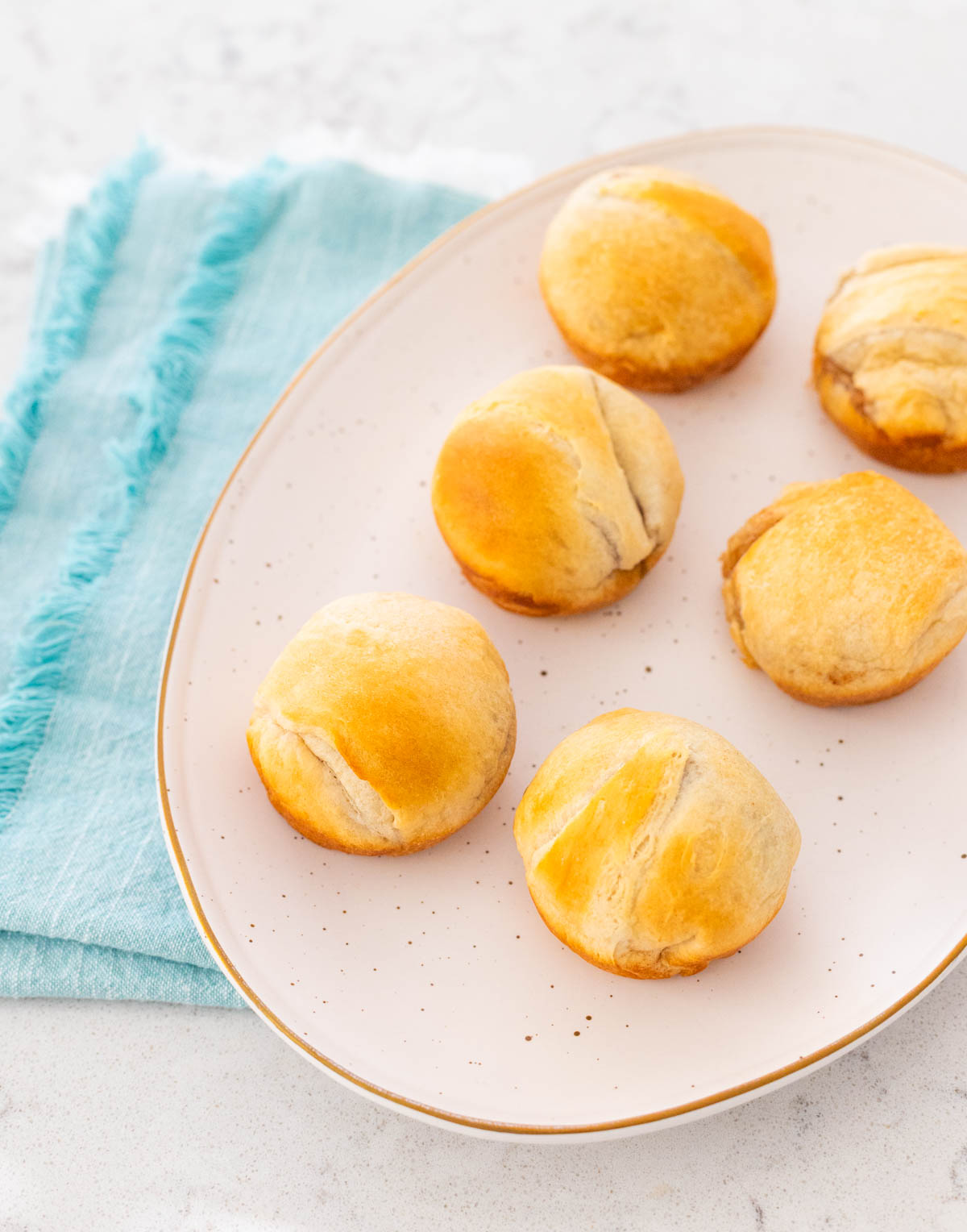 A platter of baked rolls is ready to be served.