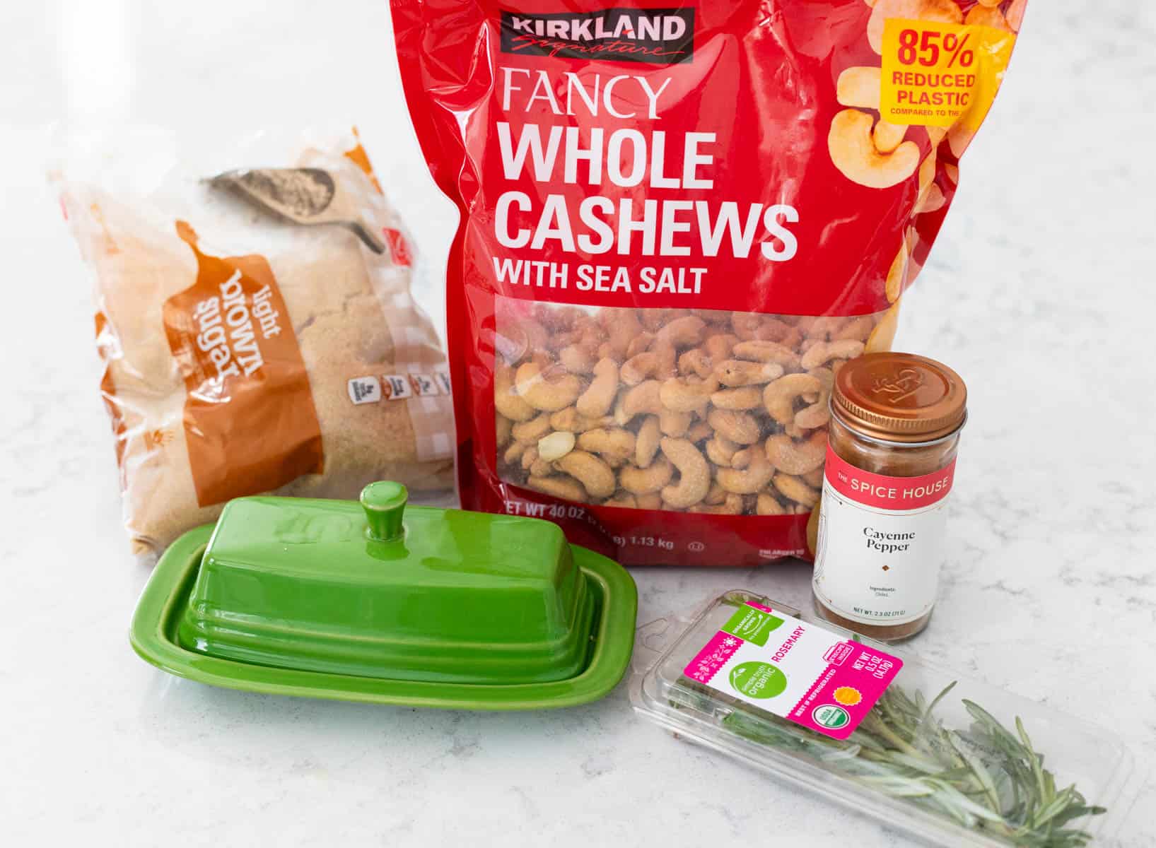 The ingredients to make roasted rosemary cashews are on the counter.