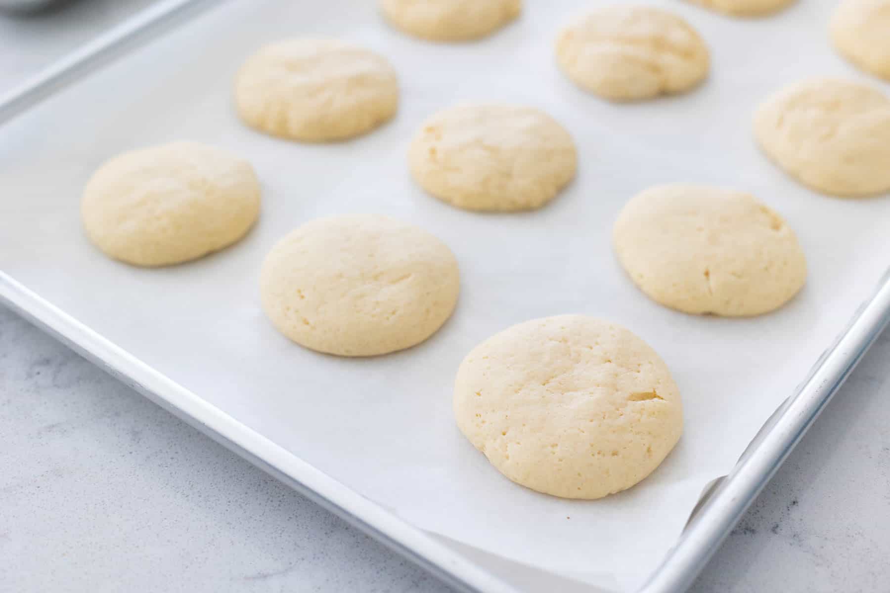 The close up photo shows the texture of the baked sugar cookies and how they puff up a bit in the center.