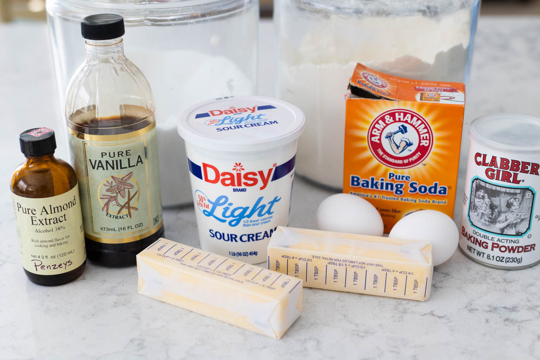 The ingredients to make soft sugar cookies with frosting are on the counter.