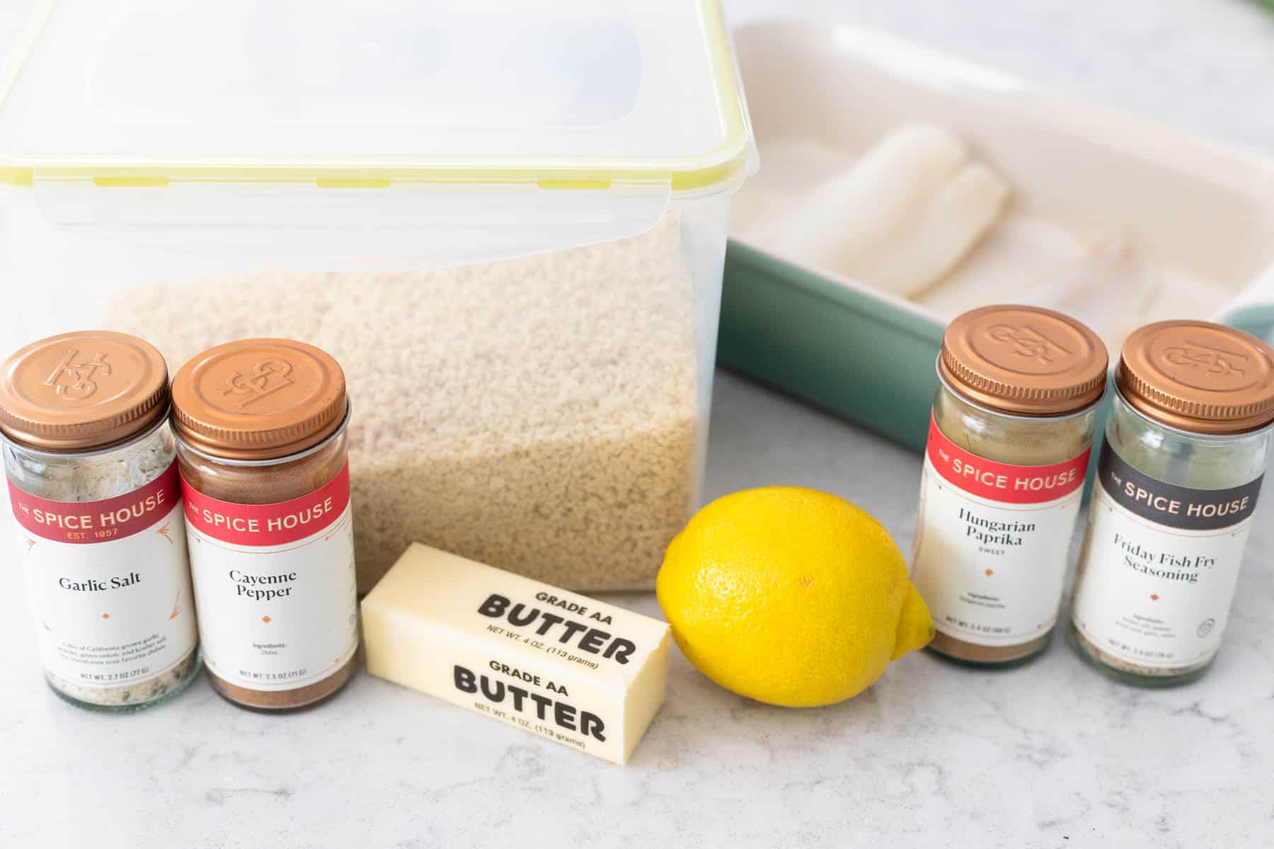 The ingredients to make baked fish with breadcrumbs are on the counter.