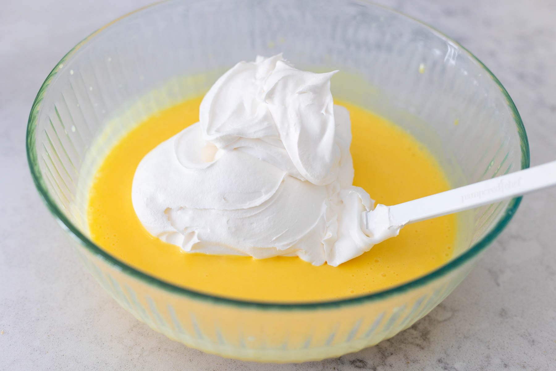 The mixing bowl has the vanilla pudding with the cool whip on top.