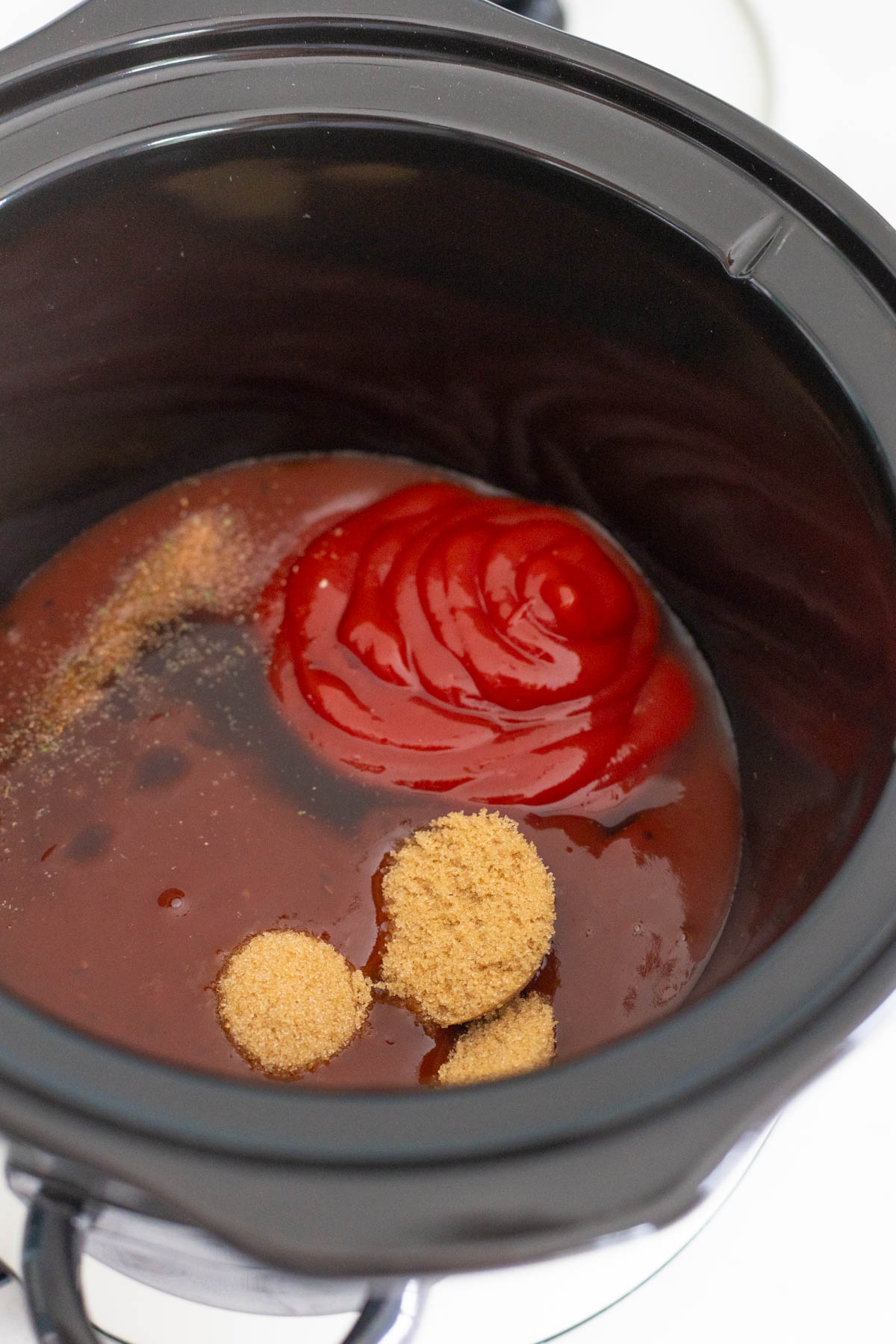 The ingredients for the tangy sauce are in the crockpot about to be stirred together.