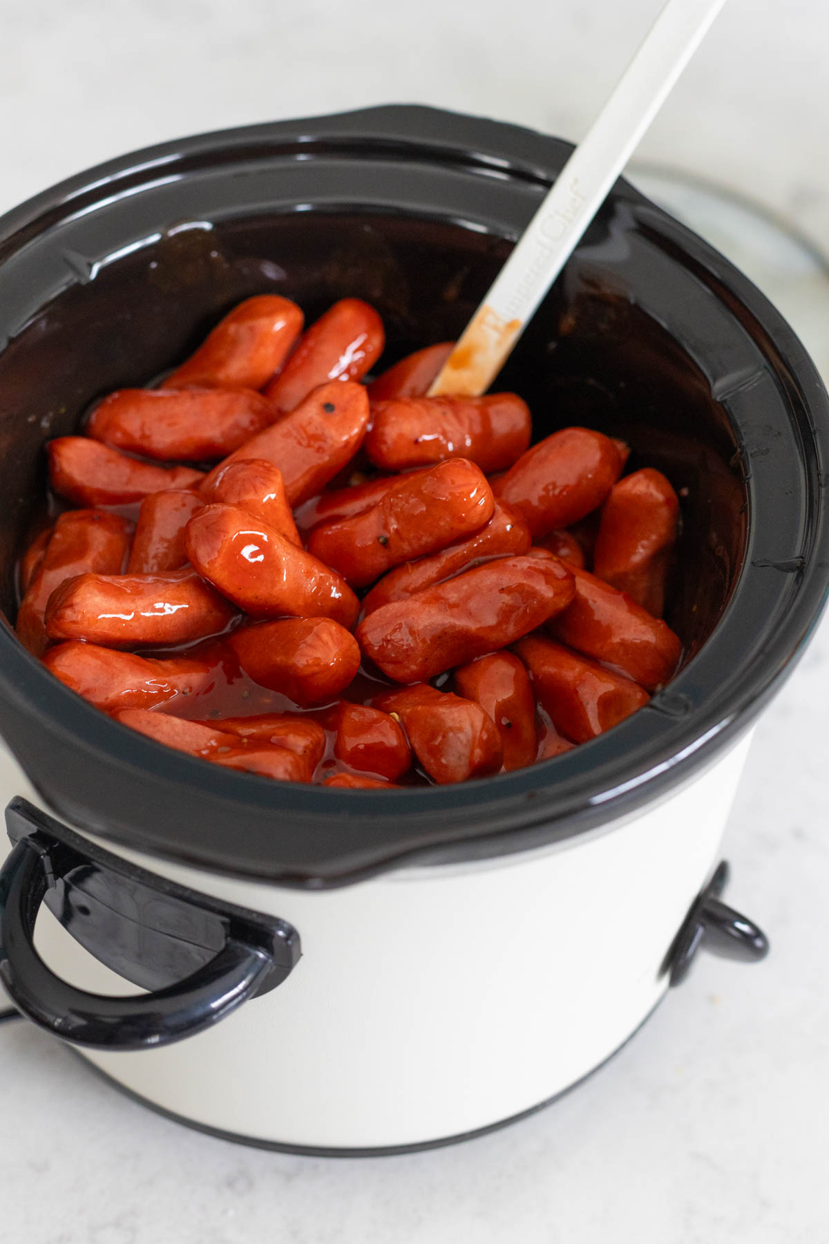 The ingredients have been stirred together and the sausages are about to be cooked in the slowcooker.