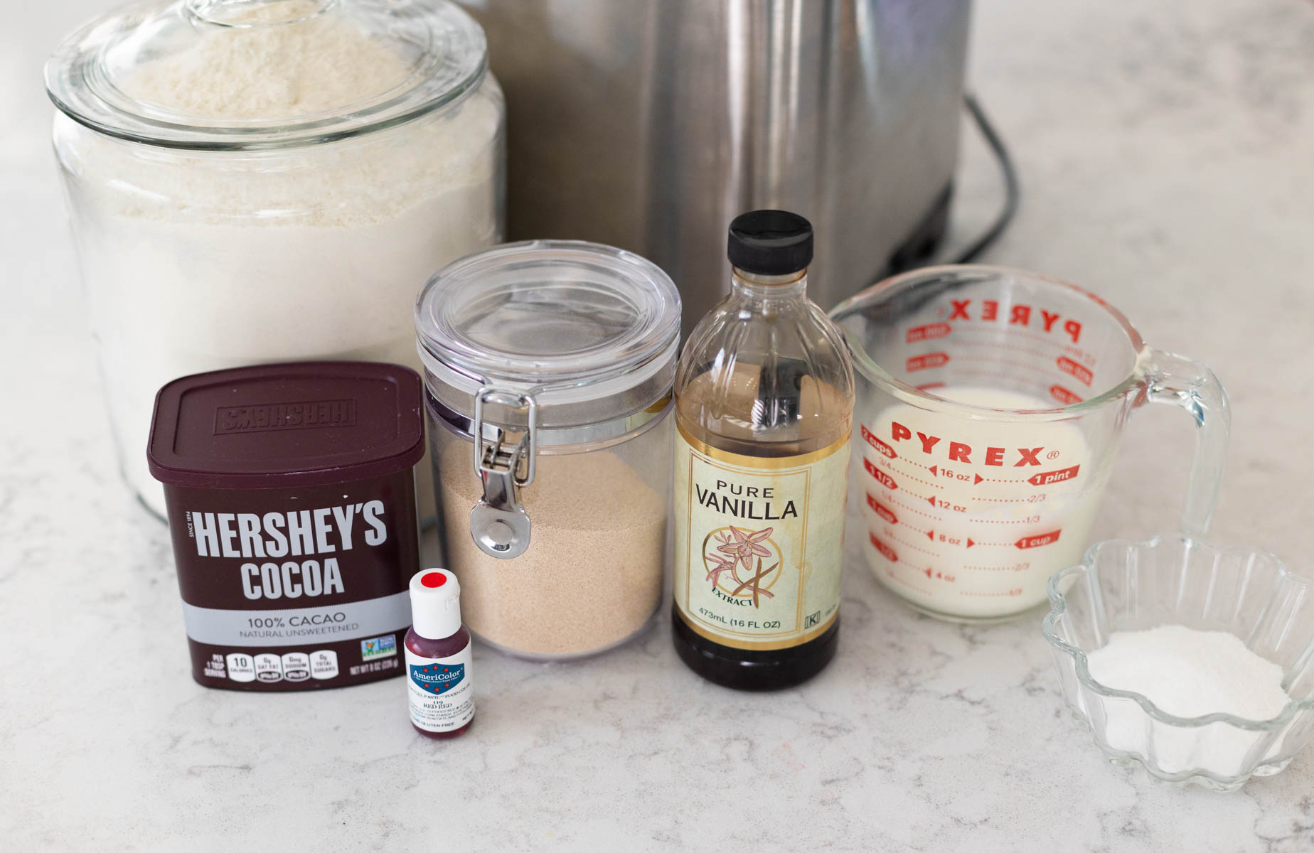 The ingredients to make red velvet cinnamon rolls are on the counter.