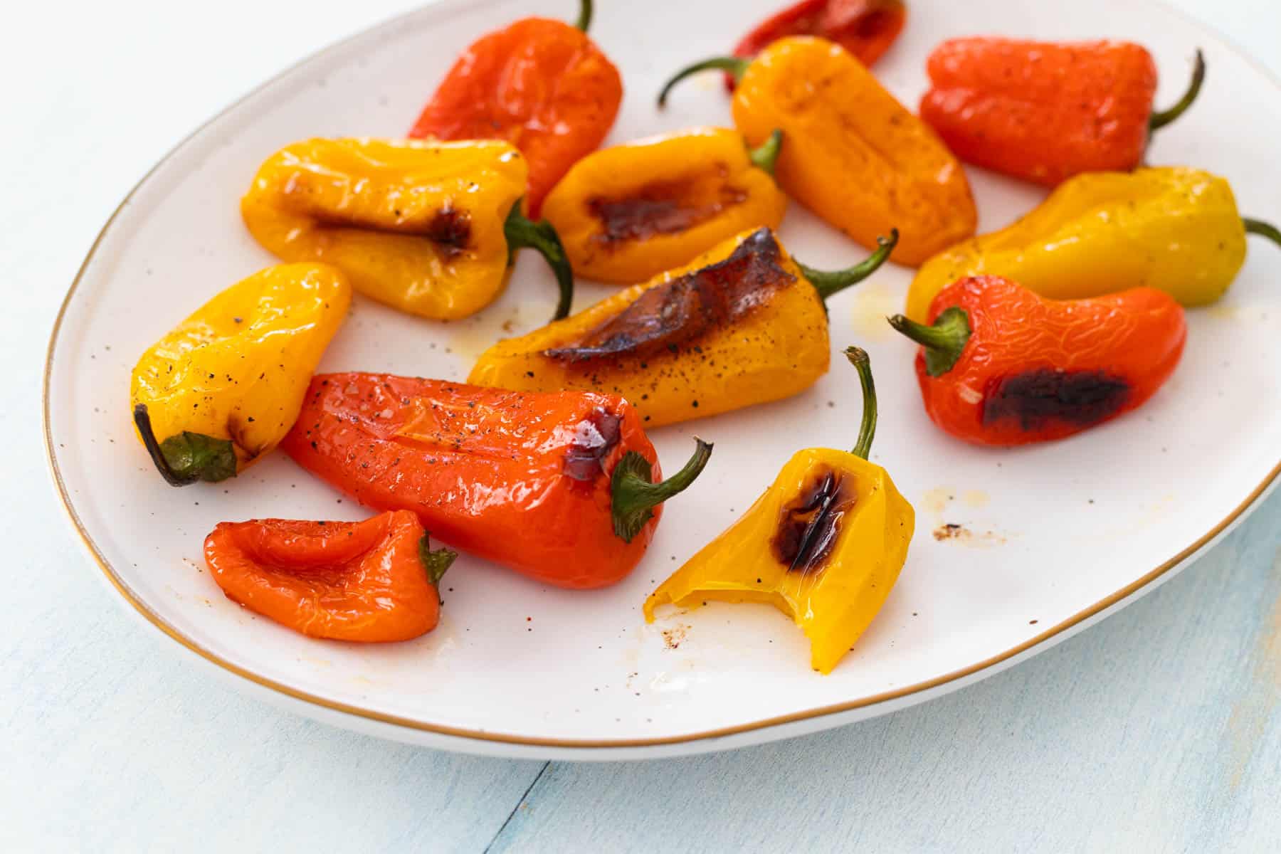 The peppers are on a serving platter at the table.