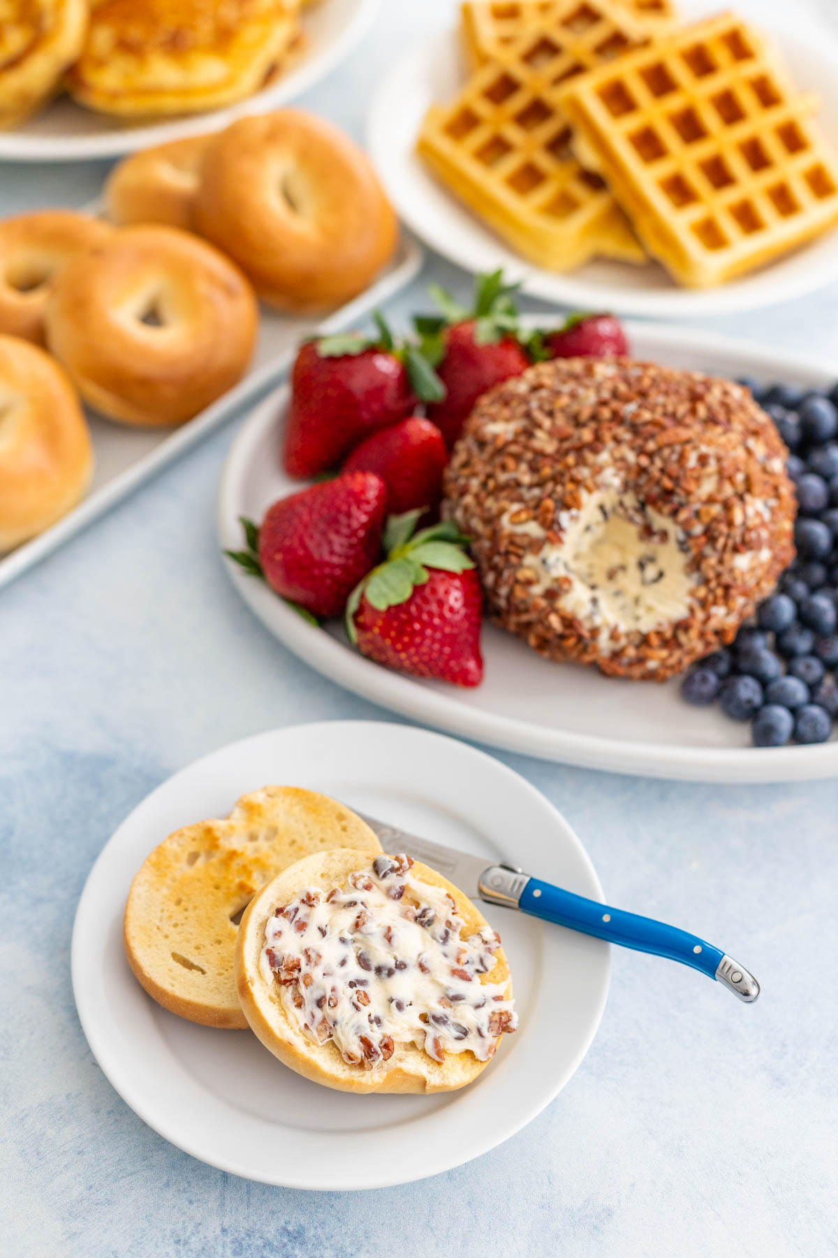 A bagel has been spread with a bit of the chocolate chip cheese ball.