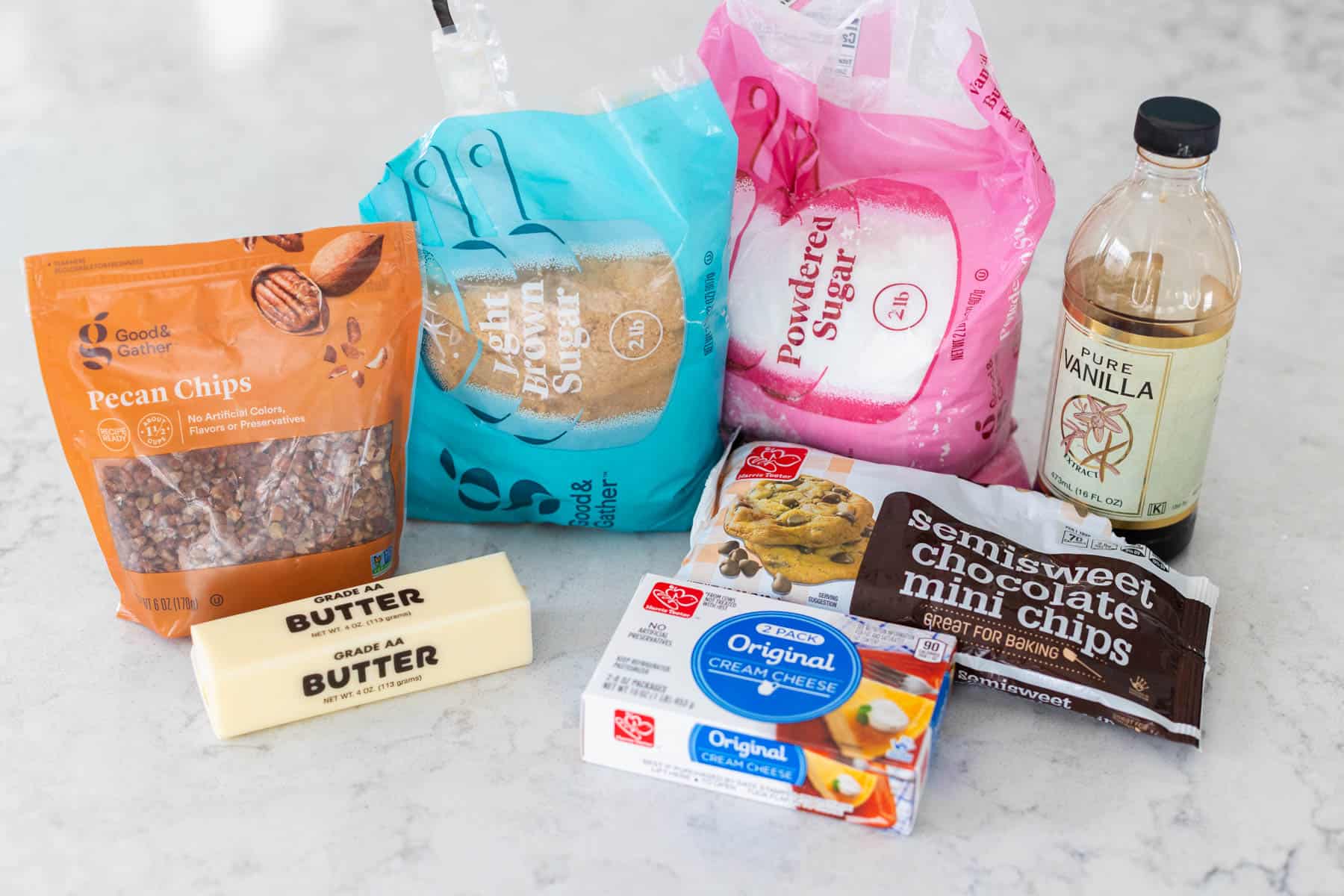 The ingredients to make a chocolate chip cheese ball are on the counter.