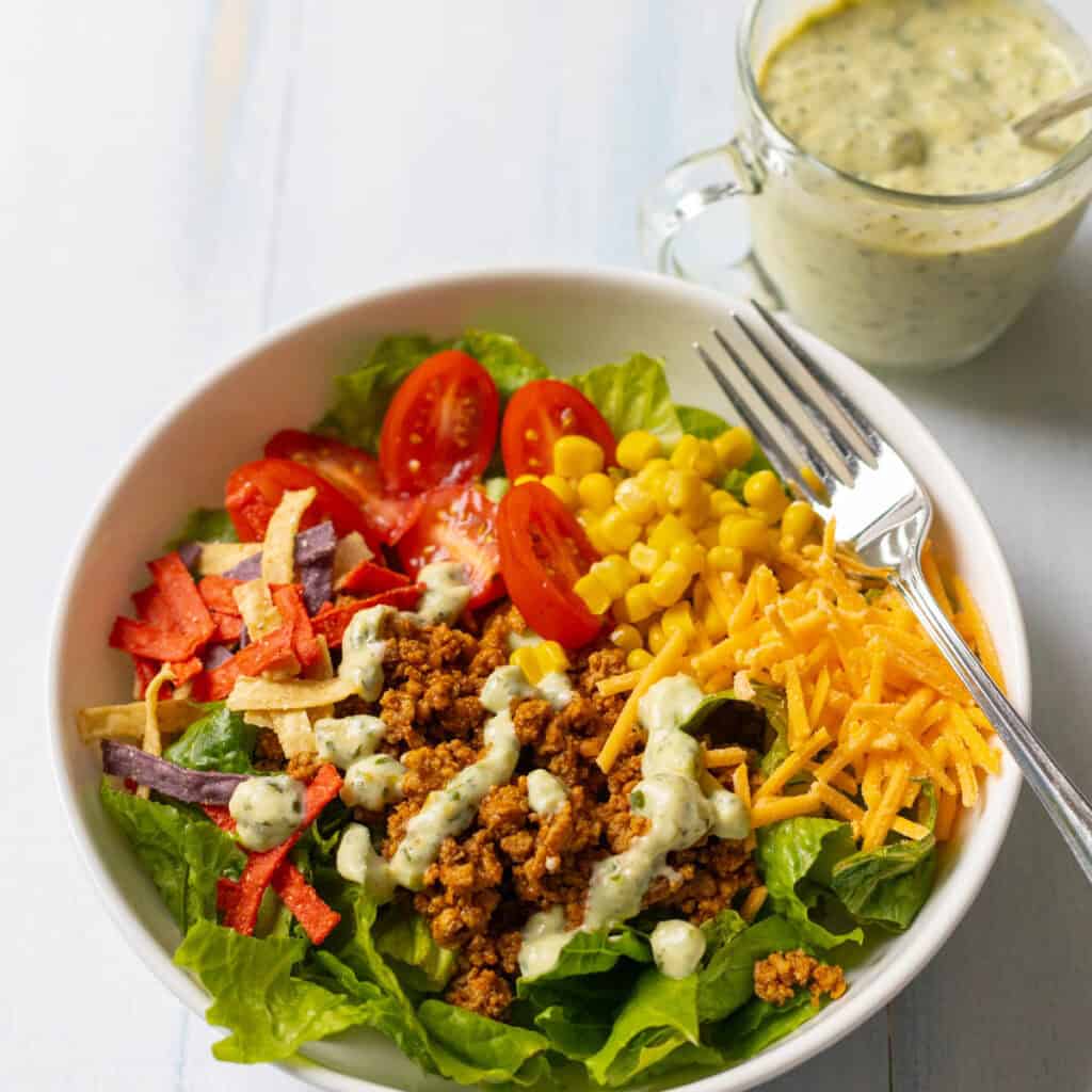 The taco salad bowl has ground turkey, tomatoes, shredded cheese, and tortilla strips.