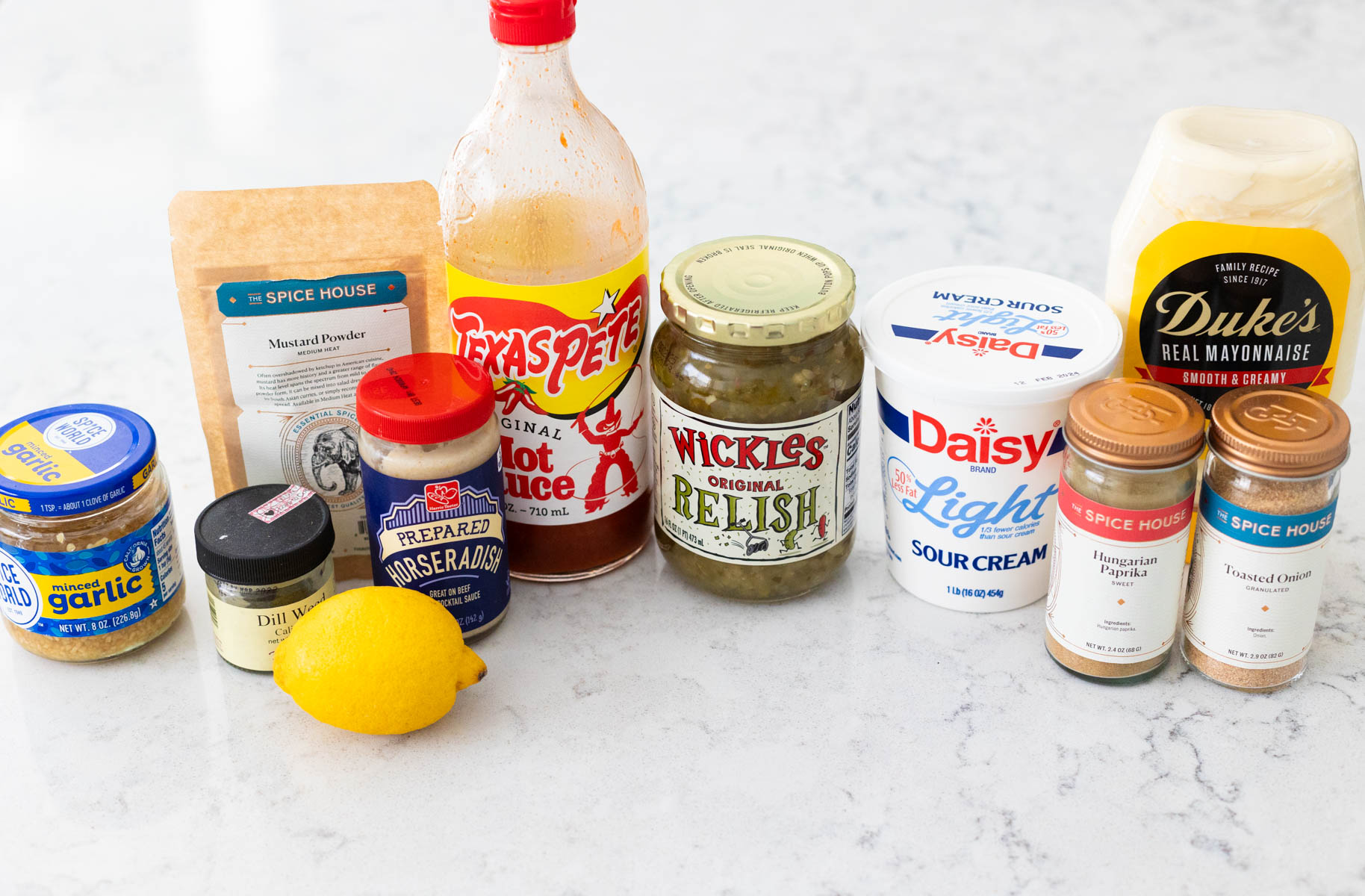 The ingredients to make homemade tartar sauce for fish are on the counter.