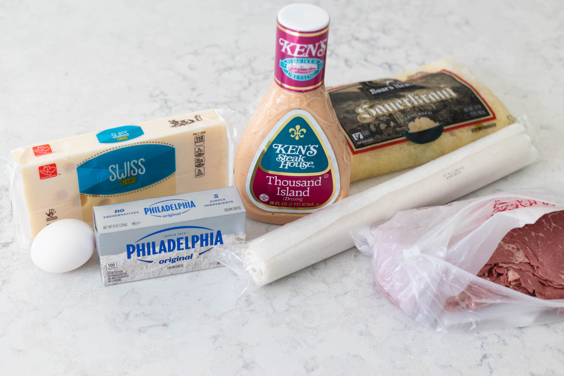 The ingredients to make reuben pinwheels are on the counter.