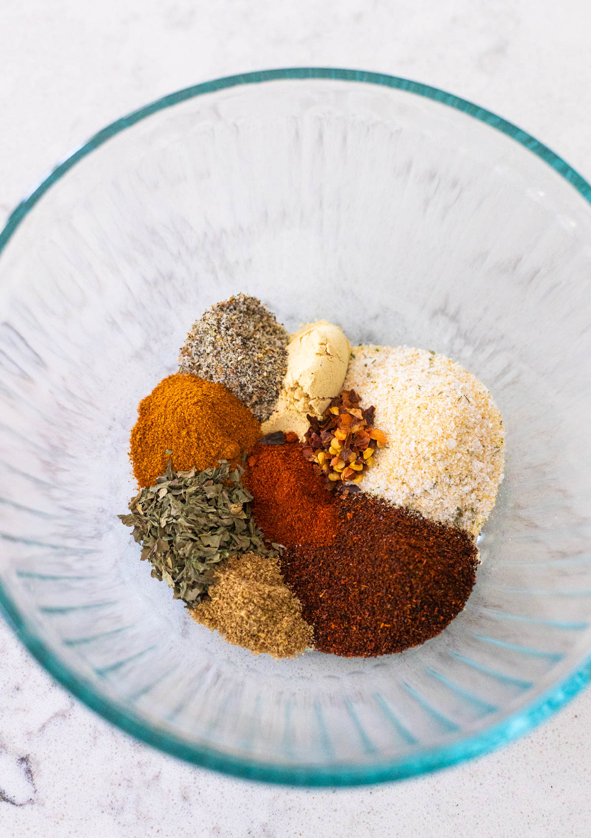 The spices have been measured and added to the mixing bowl.