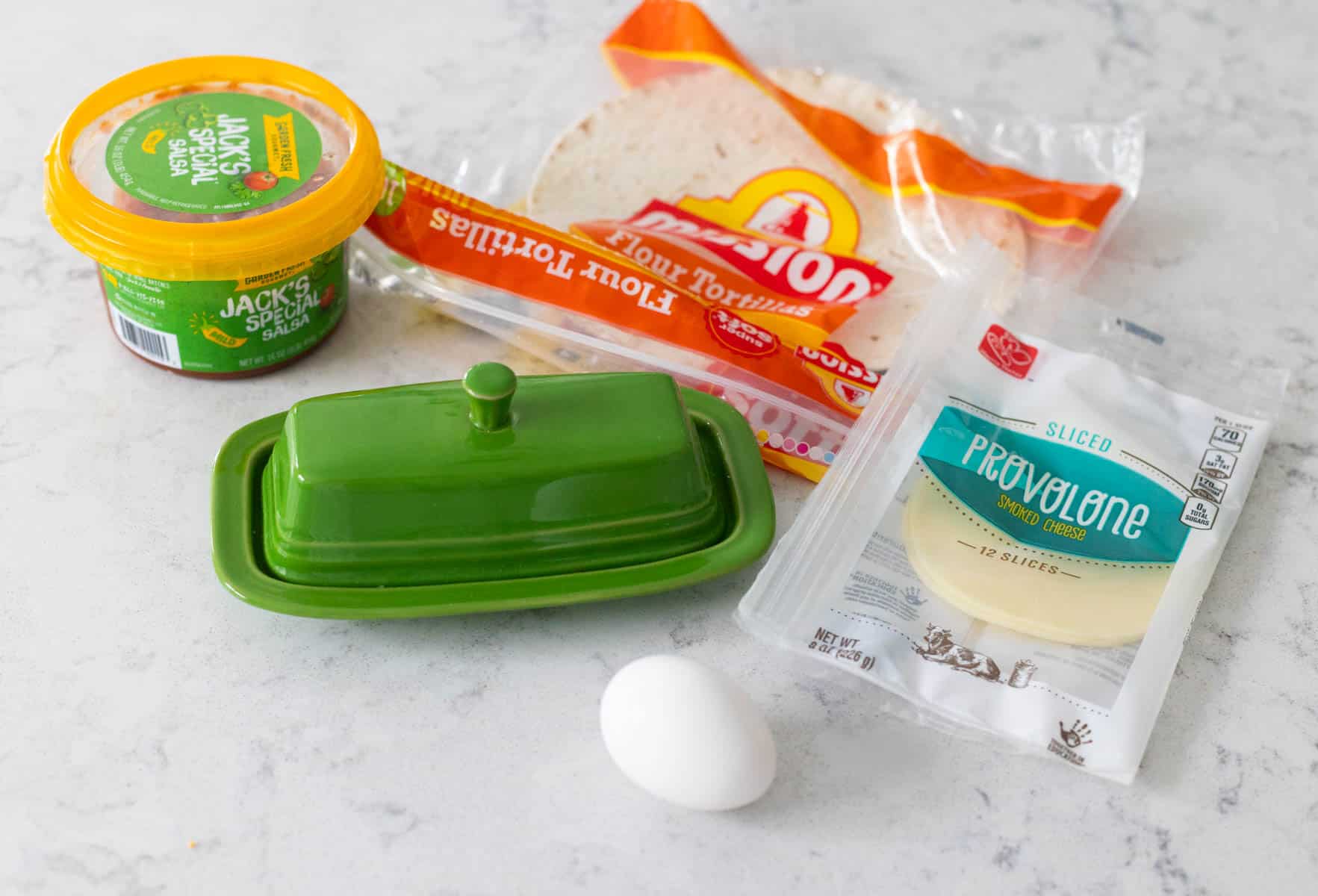 The ingredients to make the egg and cheese quesadillas are on the counter.