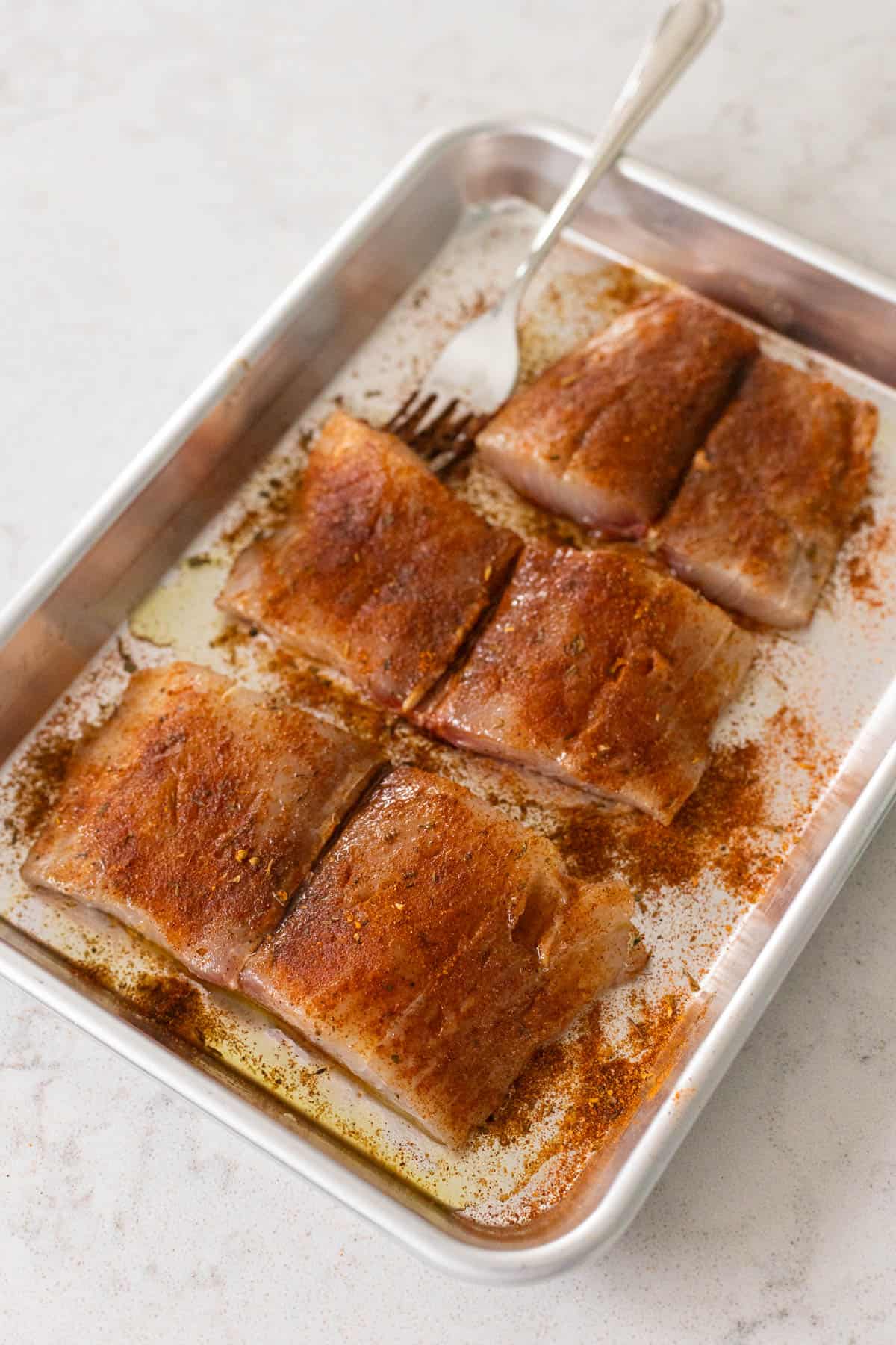 The mahi mahi has been coated in blackening seasoning.
