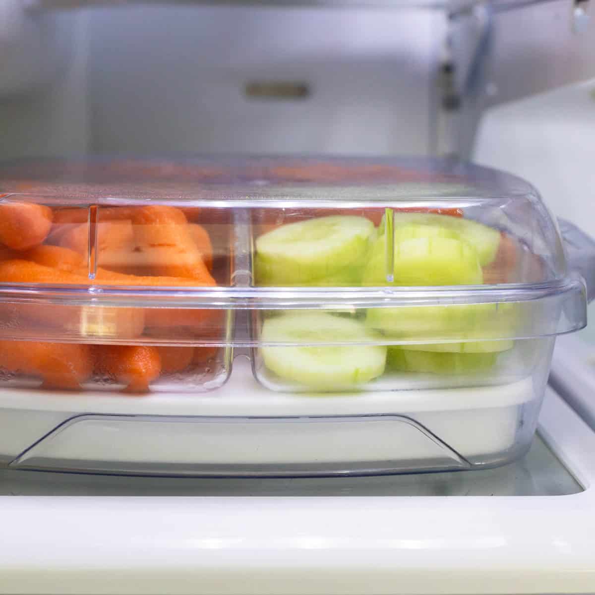 Baby carrots and pre-sliced cucumbers in a veggie tray.