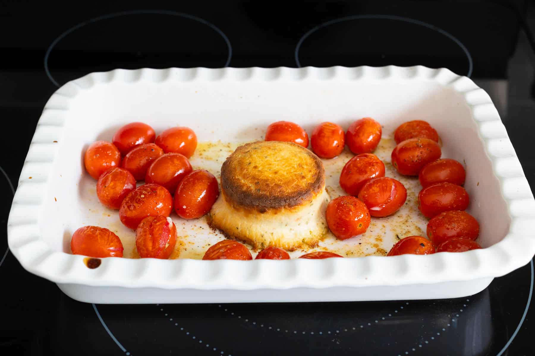 The dish has come out of the oven, the boursin cheese is toasted brown and the cherry tomatoes have burst.