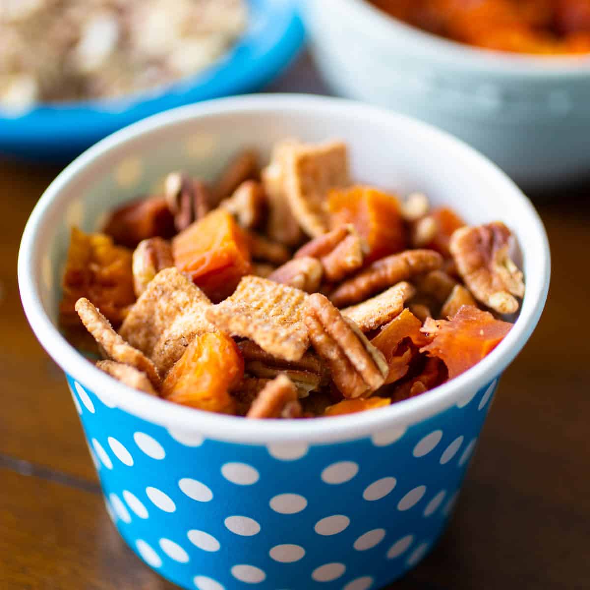 The cinnamon cereal is mixed with dried peaches and pecans.