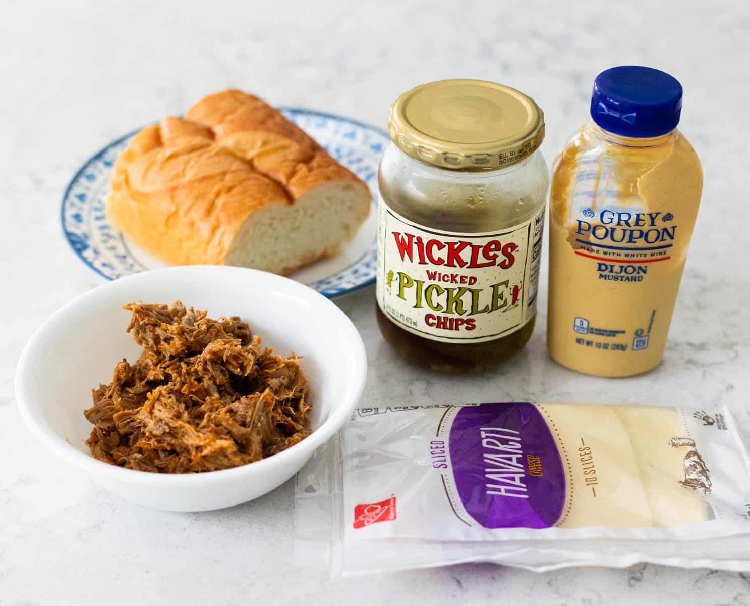 The ingredients to make Cuban pork sandwiches are on the counter.