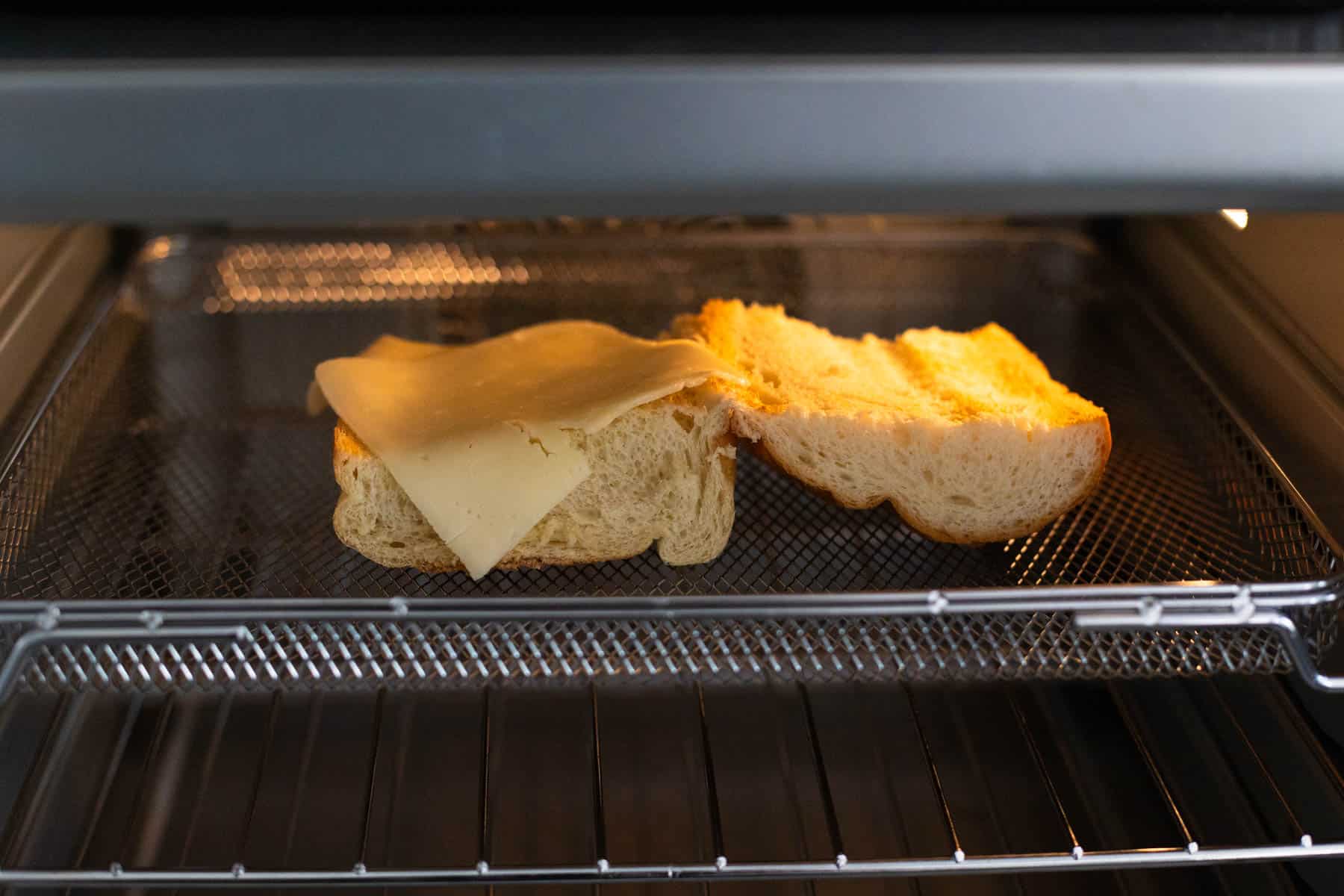 The French bread is under the broiler toasting.