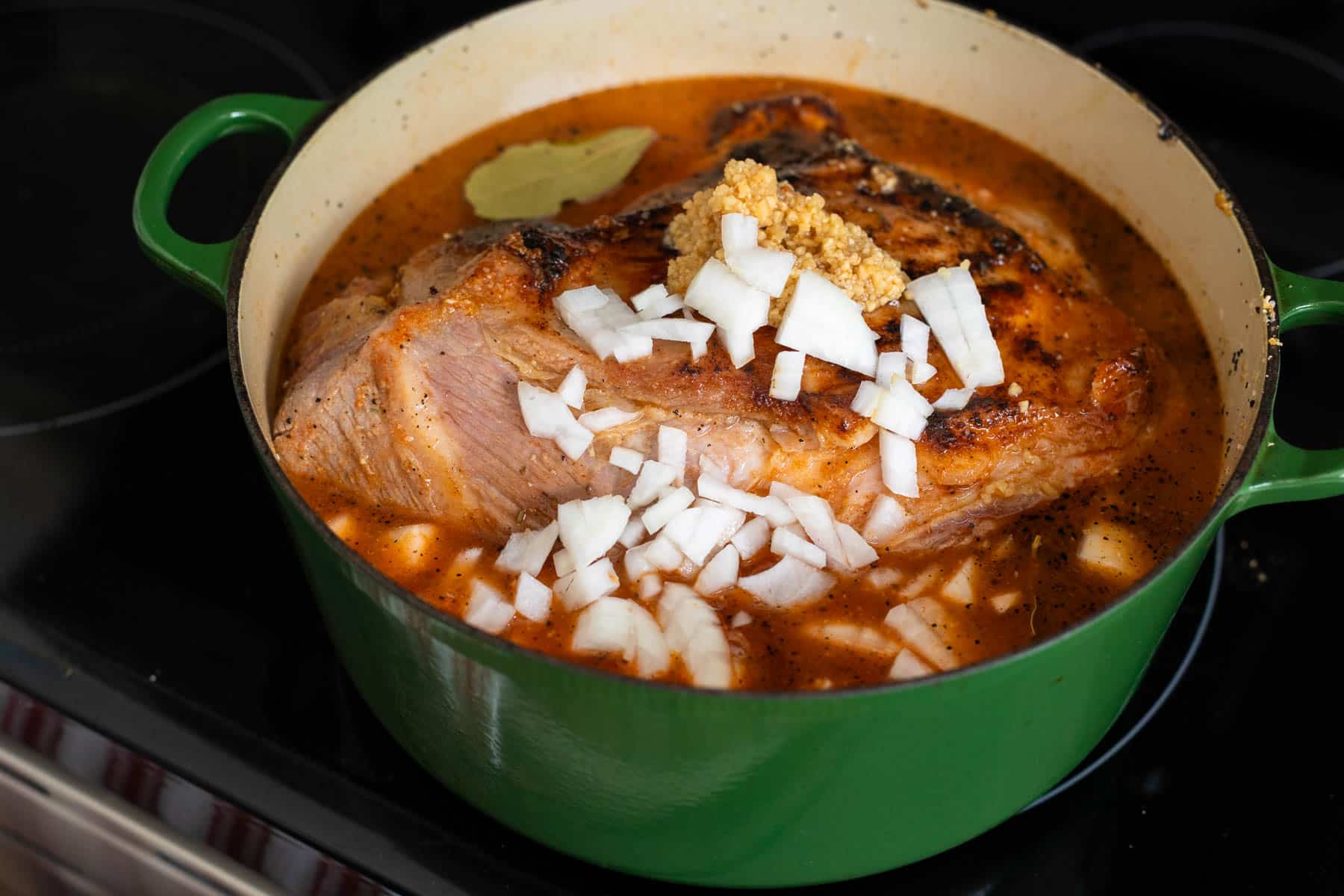 The pork has been covered with the mojo marinade.