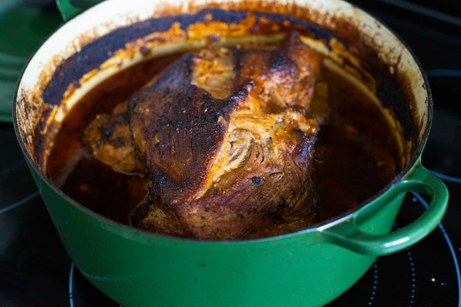 The Cuban pork has just come out of the oven and is a deep brown color. You can see the cooking liquid has reduced. 