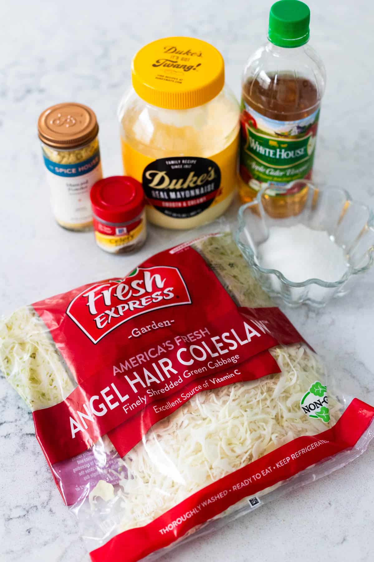 The ingredients to make the creamy slaw are on the counter.